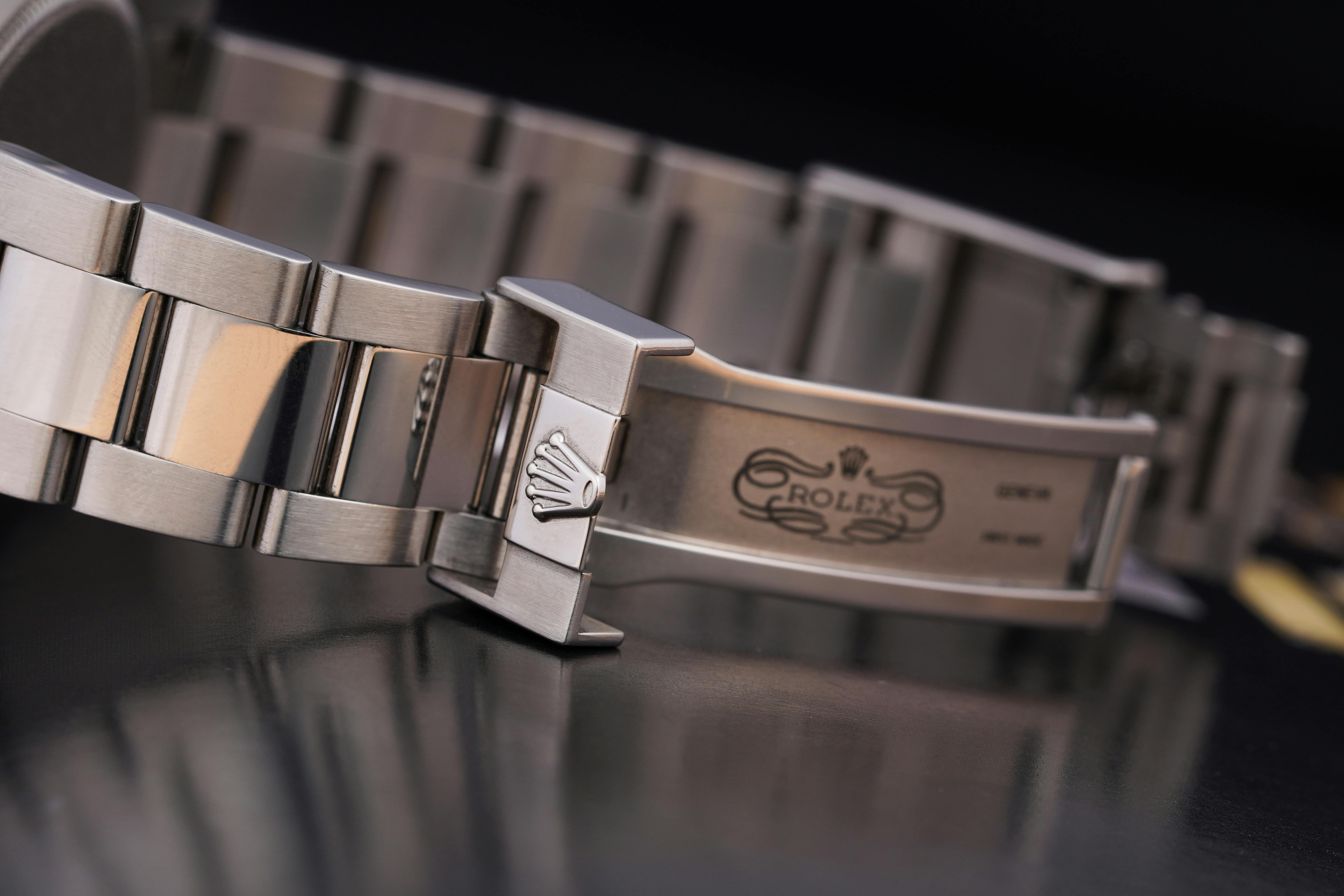 Close-up of a luxury silver watch bracelet showcasing intricate design details.